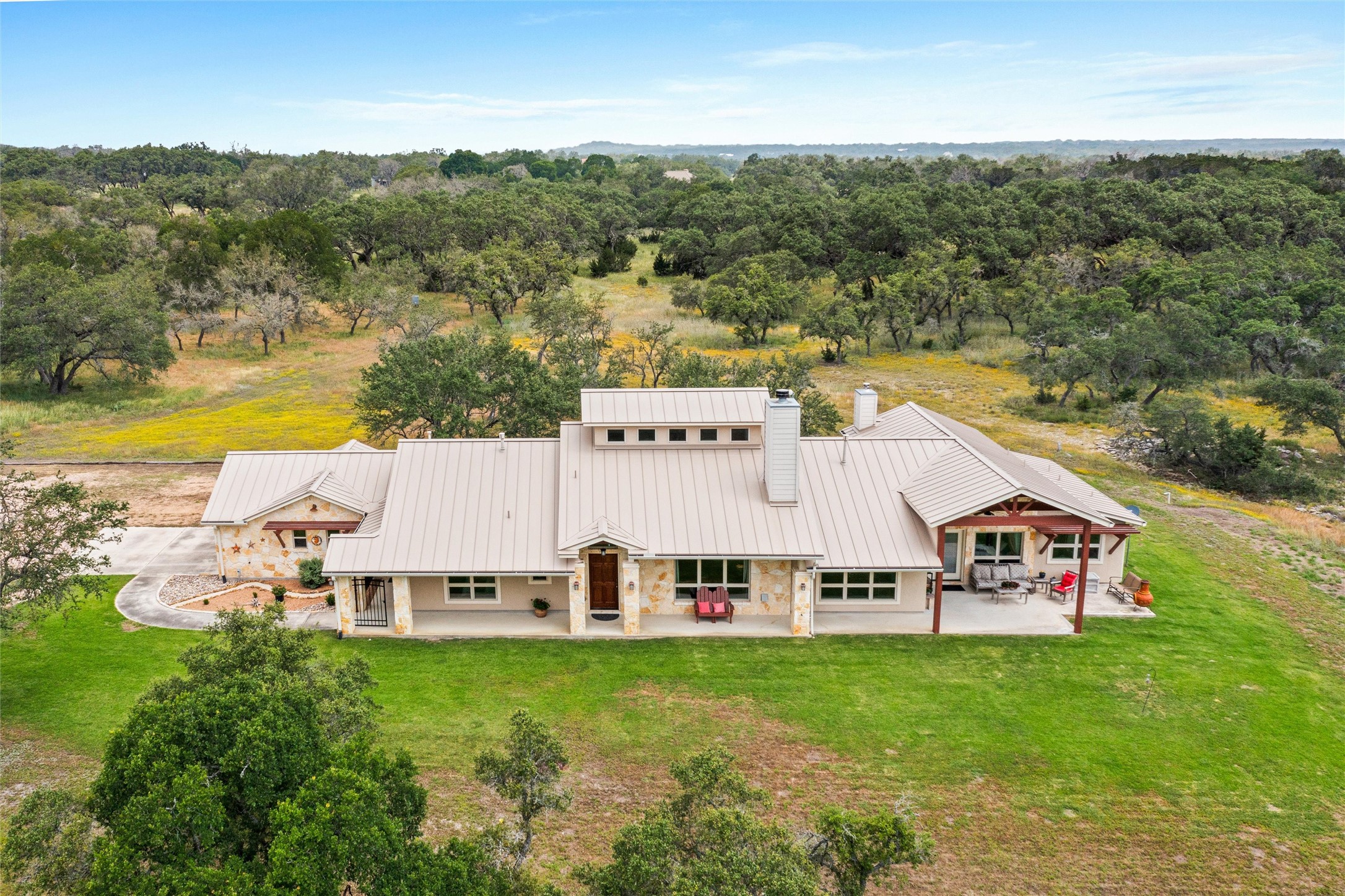 426 Preiss Ranch Road Blanco, TX 78606 - Photo 39 of 40 a view of a swimming pool with lawn chairs and large trees