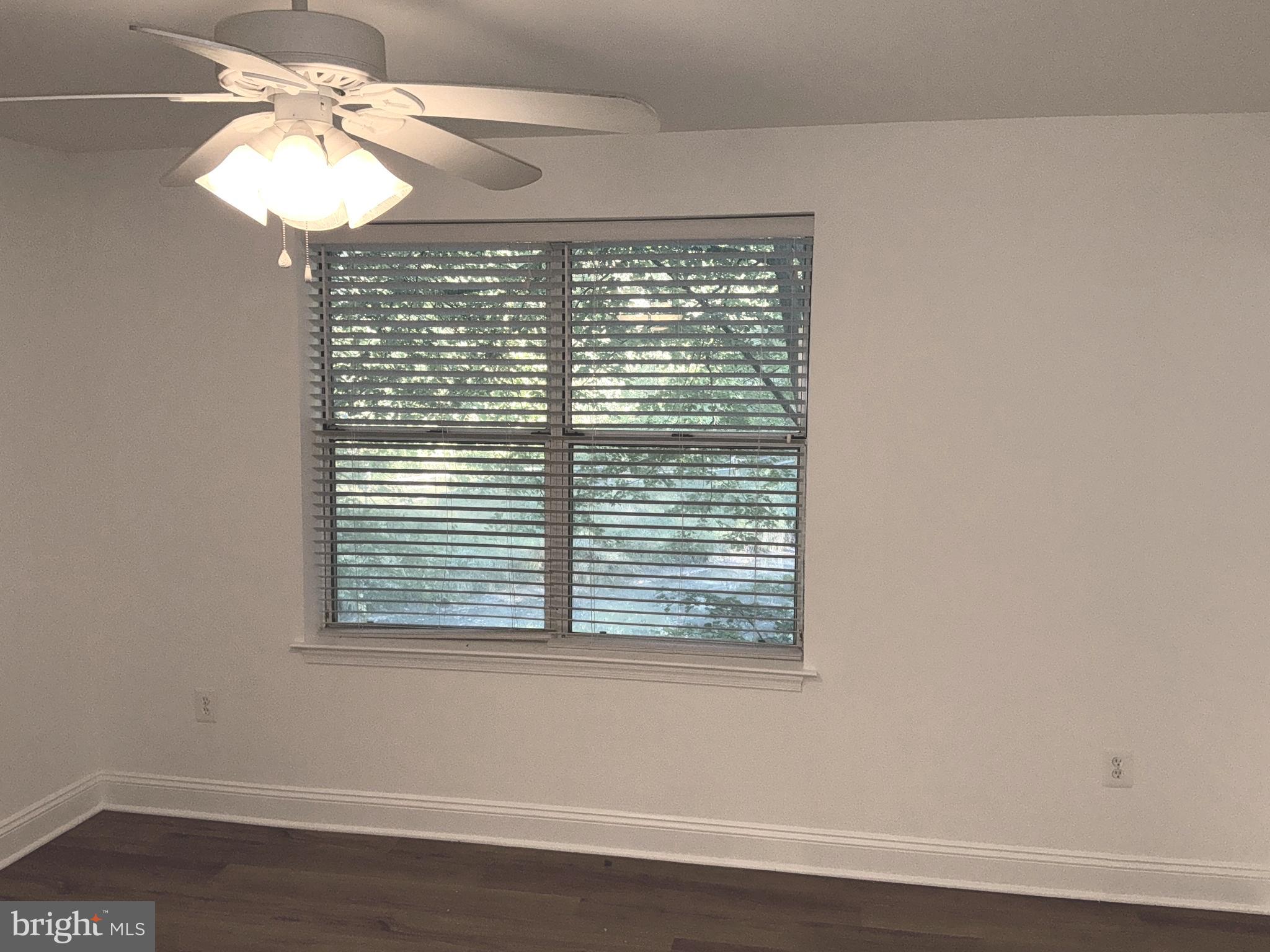 10003 Vanderbilt Circle, Unit 11 Rockville, MD 20850 - Photo 11 of 23 a view of a small space with wooden floor and a window