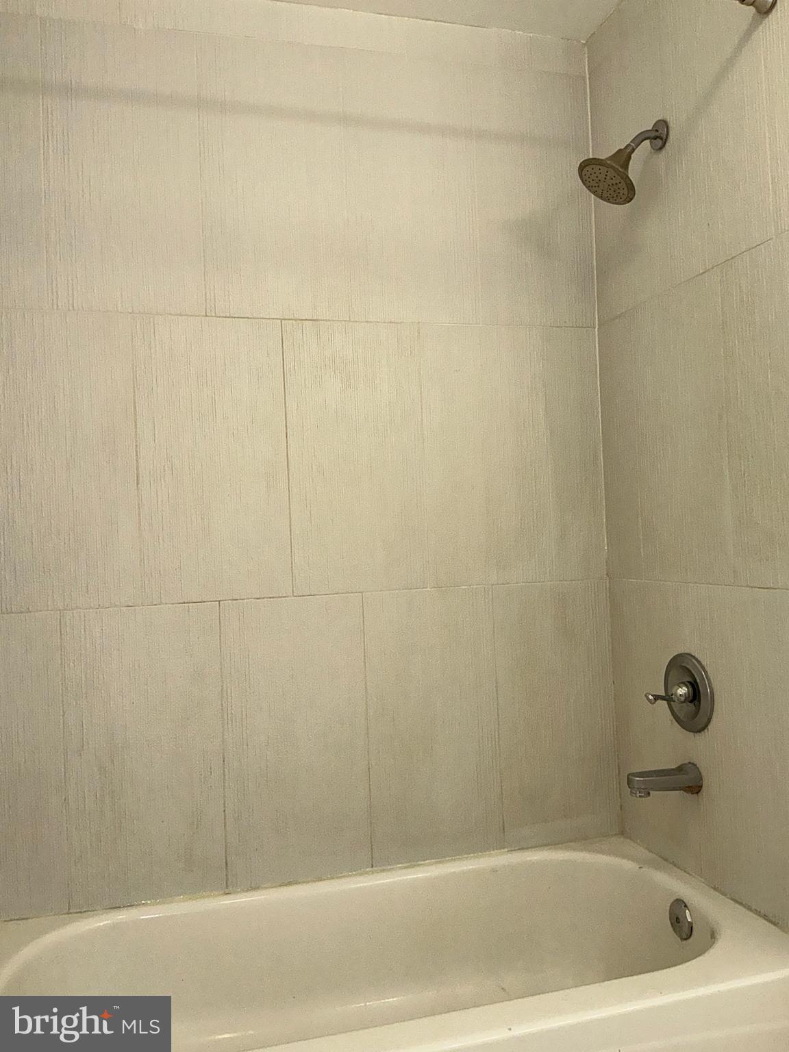 10003 Vanderbilt Circle, Unit 11 Rockville, MD 20850 - Photo 14 of 23 a bathroom with a bathtub