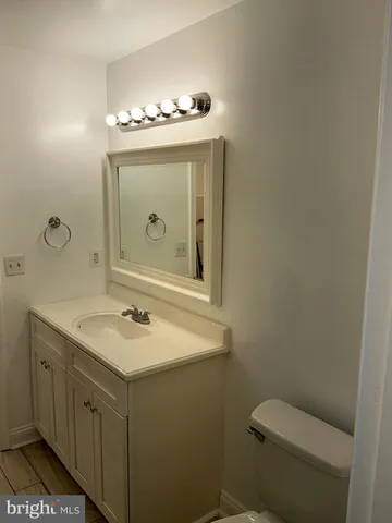 a bathroom with a sink a toilet and mirror