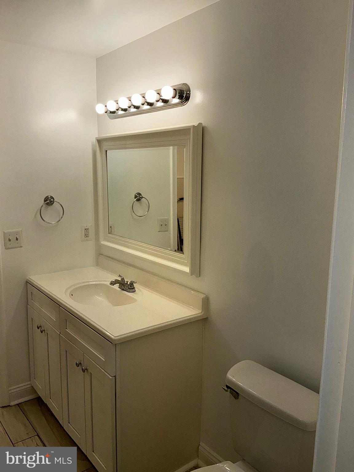 10003 Vanderbilt Circle, Unit 11 Rockville, MD 20850 - Photo 15 of 23 a bathroom with a toilet sink and mirror