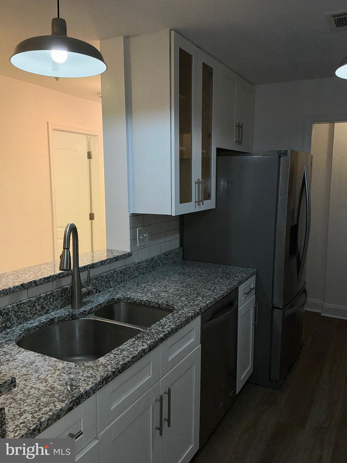 10003 Vanderbilt Circle, Unit 11 Rockville, MD 20850 - Photo 5 of 23 a kitchen with stainless steel appliances granite countertop a sink a refrigerator and a granite counter tops