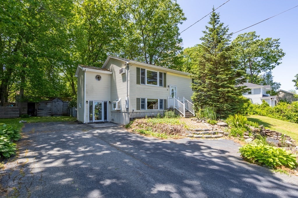56 Lake Shore Road Salem, NH 03079 - Photo 1 of 39 a front view of a house with a yard and garage