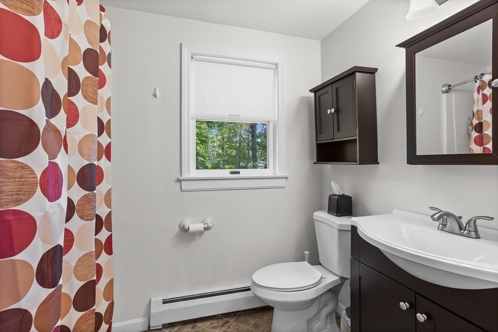 56 Lake Shore Road Salem, NH 03079 - Photo 16 of 39 a bathroom with a sink and mirror with toilet