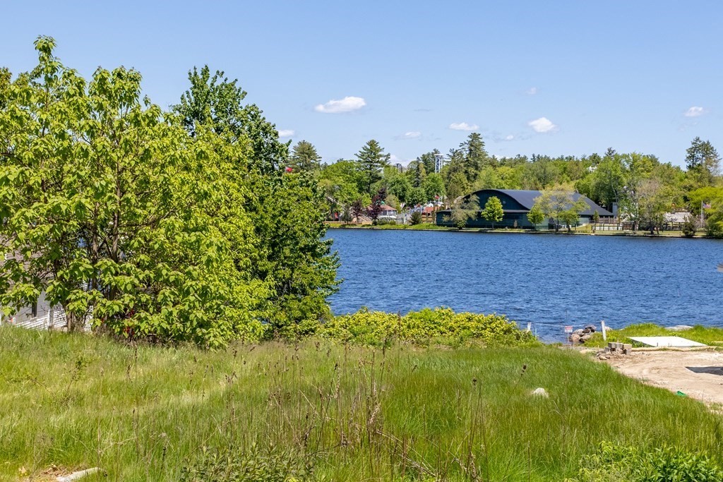 56 Lake Shore Road Salem, NH 03079 - Photo 2 of 39 a view of a garden with a lake