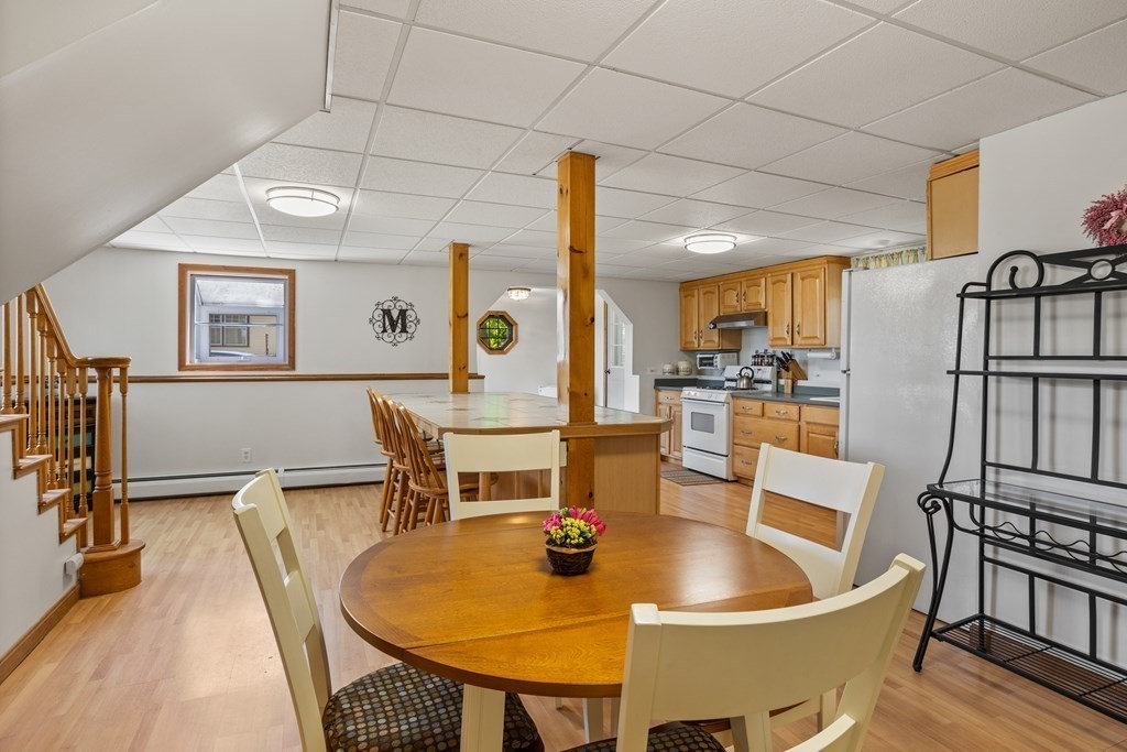 56 Lake Shore Road Salem, NH 03079 - Photo 27 of 39 a dining room with furniture and wooden floor