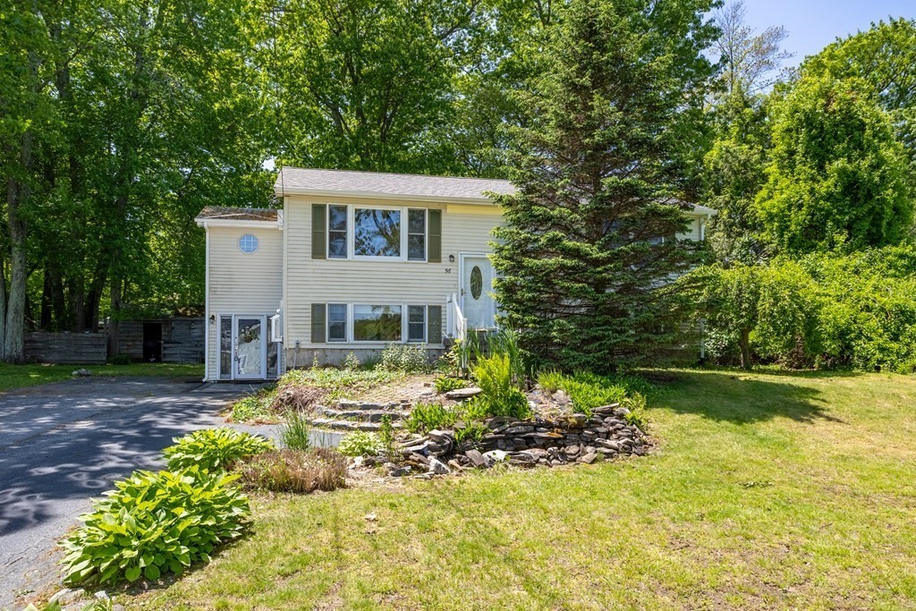 56 Lake Shore Road Salem, NH 03079 - Photo 3 of 39 a front view of a house with a yard