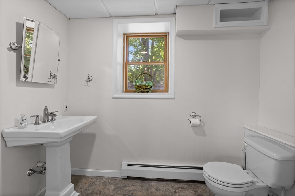 56 Lake Shore Road Salem, NH 03079 - Photo 33 of 39 a bathroom with a sink mirror toilet and next to a window