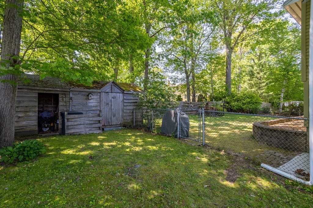 56 Lake Shore Road Salem, NH 03079 - Photo 38 of 39 a view of a backyard with wooden fence and a bench