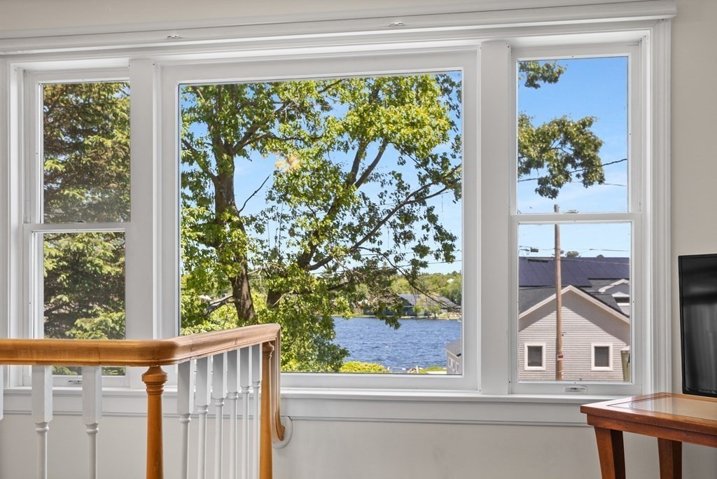 56 Lake Shore Road Salem, NH 03079 - Photo 10 of 39 a view of a balcony with a tree