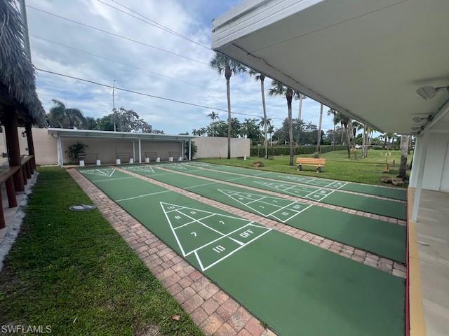 519 Riviera Boulevard East Naples, FL 34112 - Photo 20 of 23 View of home's community with a yard and shuffleboard