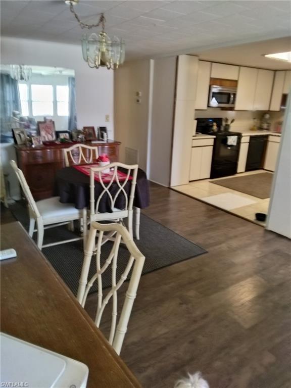 519 Riviera Boulevard East Naples, FL 34112 - Photo 6 of 23 Dining room with a chandelier and wood finished floors