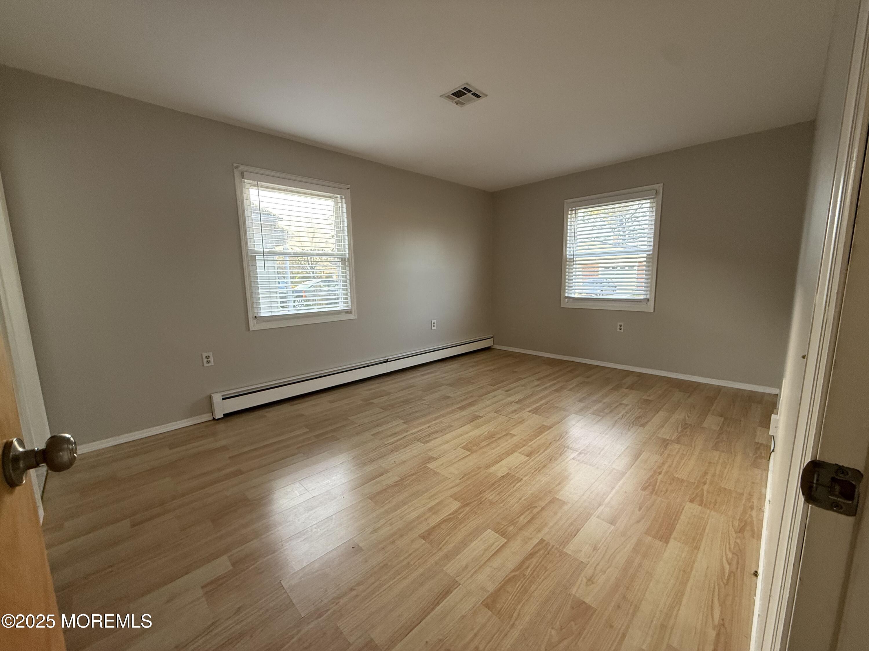 68 Virgin Islands Drive Toms River, NJ 08757 - Photo 18 of 19 a view of an empty room with wooden floor and a window