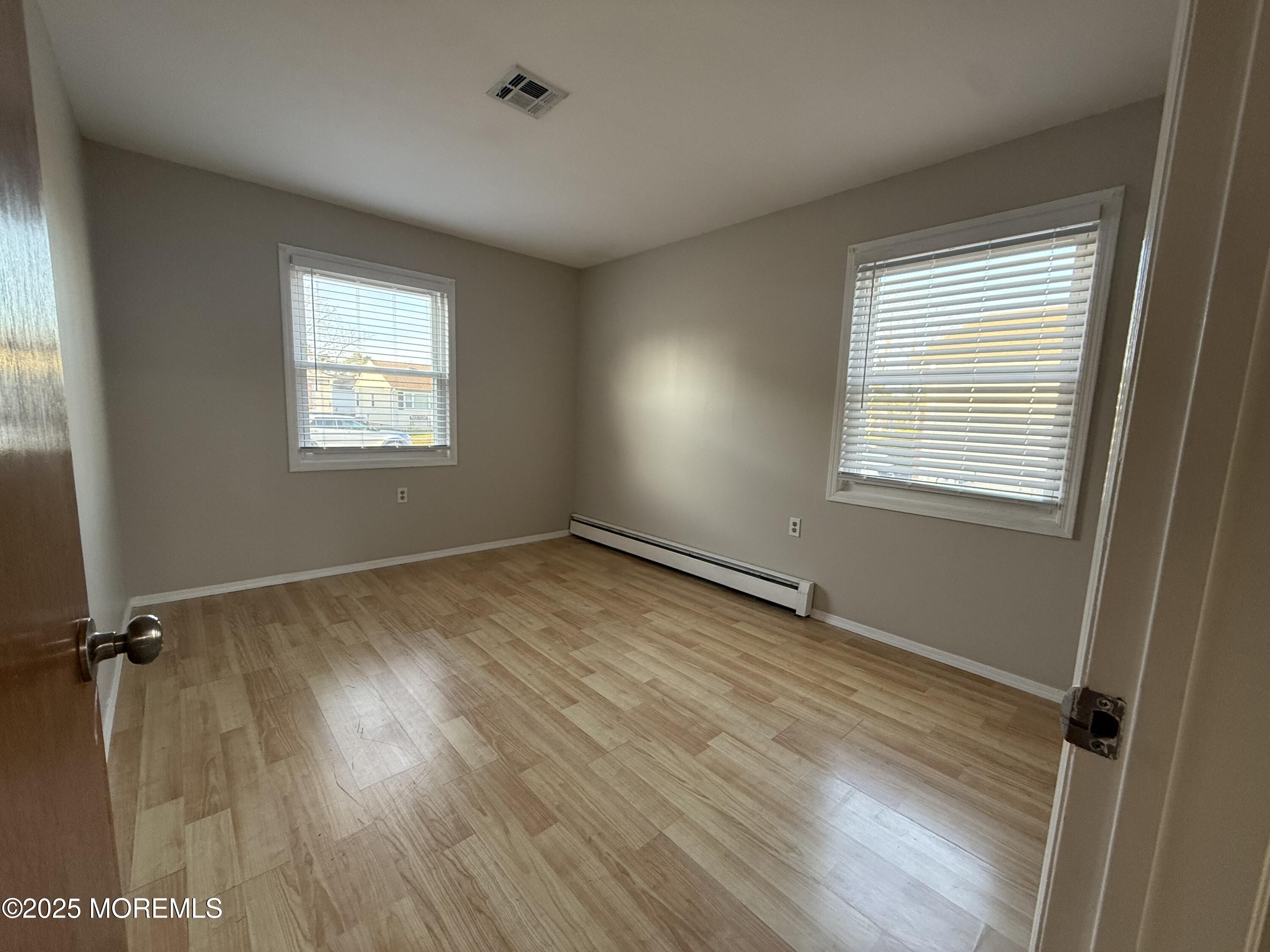 68 Virgin Islands Drive Toms River, NJ 08757 - Photo 19 of 19 a view of an empty room with a window and wooden floor