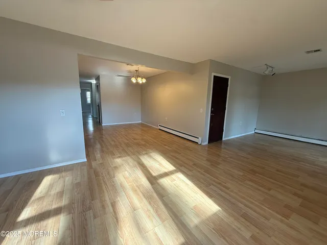 a view of hallway with wooden floor