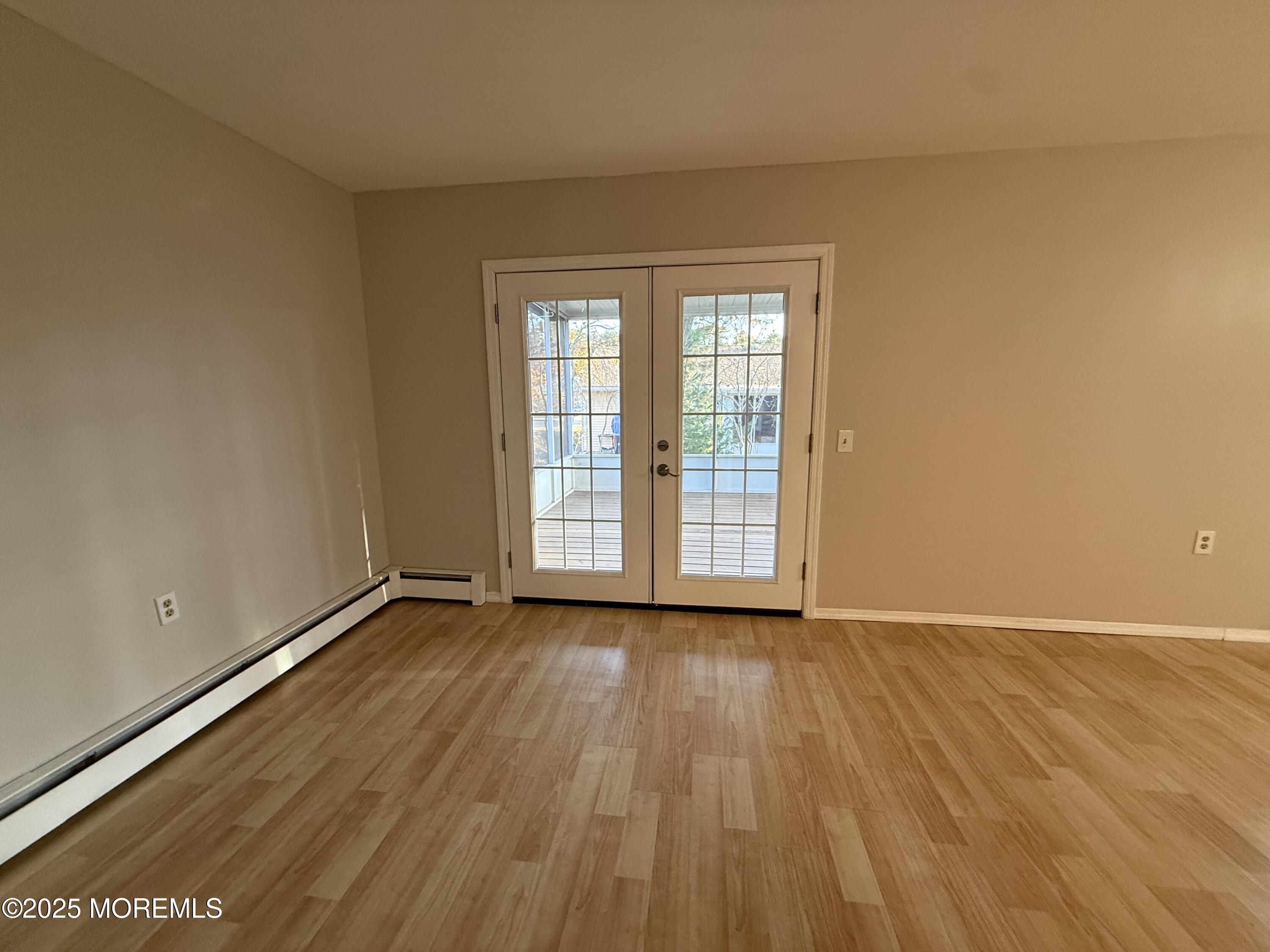 68 Virgin Islands Drive Toms River, NJ 08757 - Photo 8 of 19 an empty room with wooden floor and windows