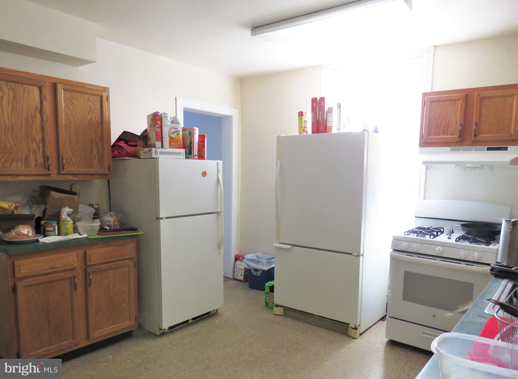 519 North 35th Street Philadelphia, PA 19104 - Photo 4 of 8 a white refrigerator freezer and a stove sitting inside of a kitchen