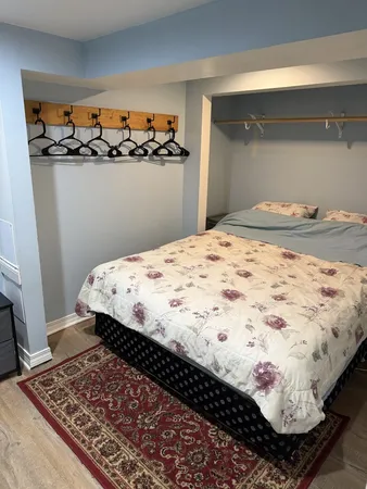 a bedroom with bed and wooden floor