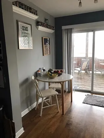 a dining room with furniture and large windows