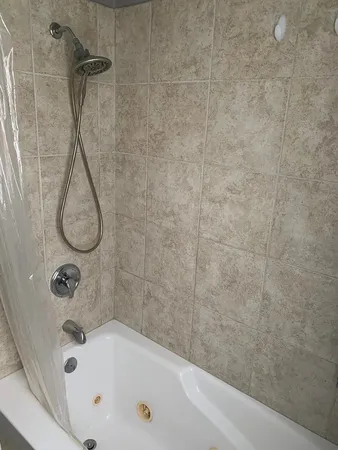 a bathroom with a tub and a shower