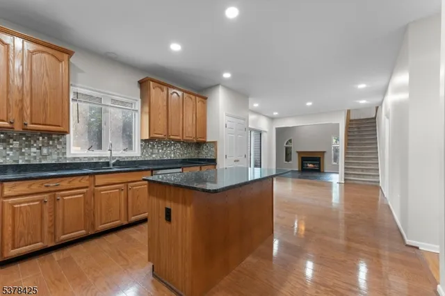 a large kitchen with stainless steel appliances granite countertop a sink and cabinets