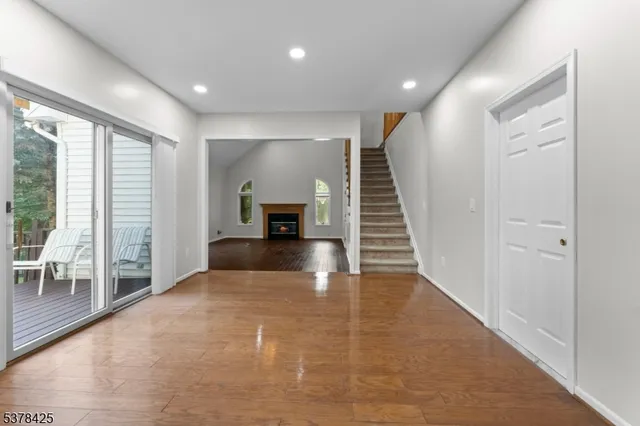 a view of empty room with wooden floor and a floor to ceiling window