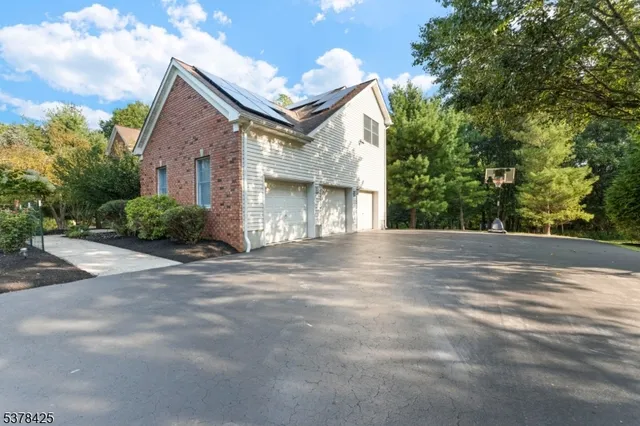 a view of a house with a yard and garage