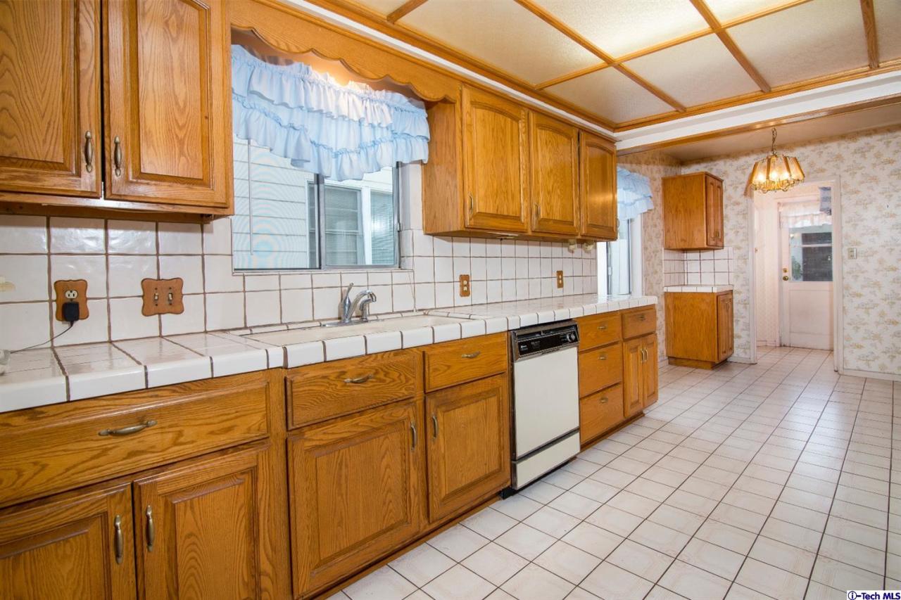 3263 Orlando Road Pasadena, CA 91107 - Photo 12 of 56 a kitchen with stainless steel appliances granite countertop a sink and cabinets