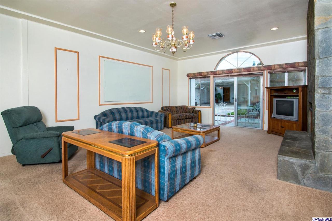 3263 Orlando Road Pasadena, CA 91107 - Photo 19 of 56 a living room with fireplace furniture and a chandelier