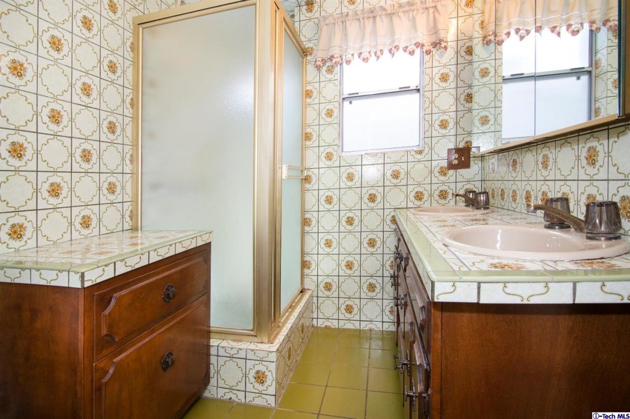 3263 Orlando Road Pasadena, CA 91107 - Photo 25 of 56 a bathroom with a granite countertop sink a vanity and a shower