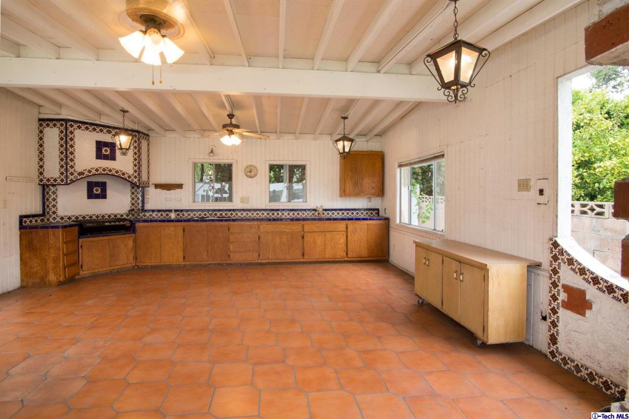 3263 Orlando Road Pasadena, CA 91107 - Photo 44 of 56 a large kitchen with stainless steel appliances granite countertop a sink dishwasher a stove a dining table and chairs with wooden floor
