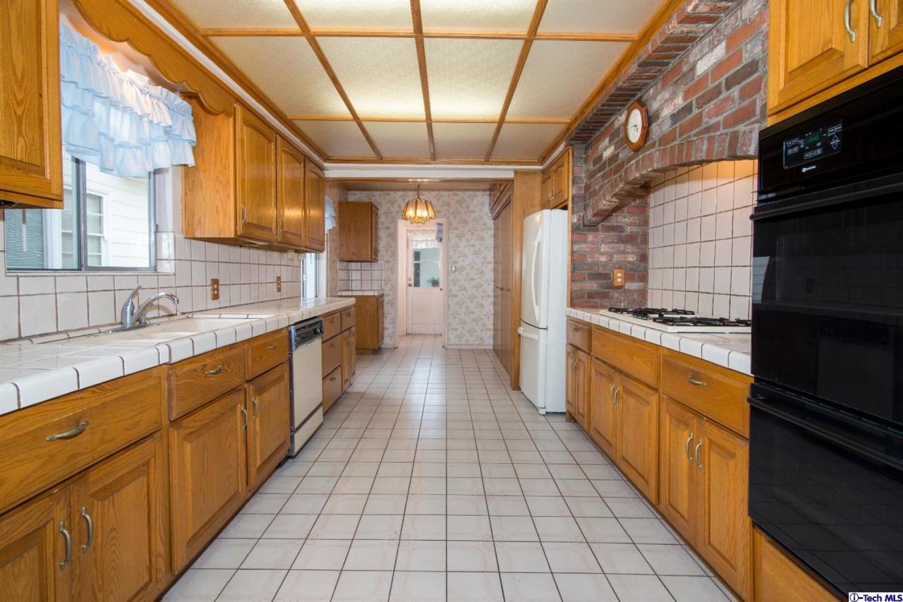 3263 Orlando Road Pasadena, CA 91107 - Photo 10 of 56 a large kitchen with stainless steel appliances granite countertop a sink and cabinets
