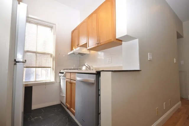 a white refrigerator freezer sitting inside of a kitchen