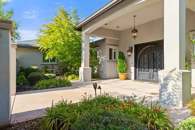 a open kitchen with stainless steel appliances kitchen island granite countertop a table chairs and a refrigerator
