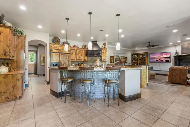a view of a house with a yard and large trees