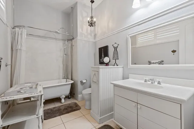 a living room with furniture a flat screen tv and a floor to ceiling window