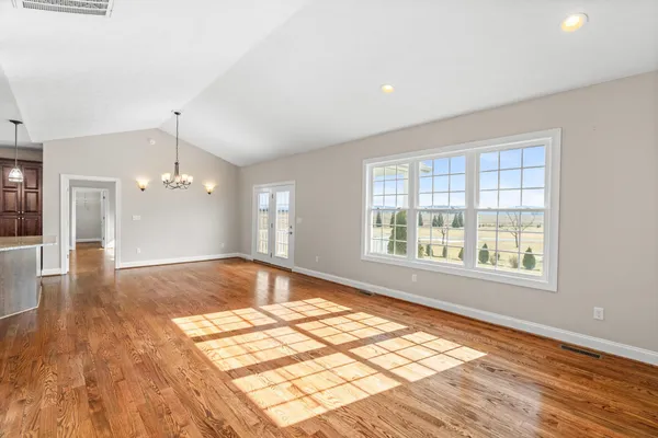 a view of a kitchen with wooden floor and a kitchen