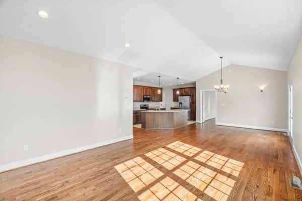 a kitchen with granite countertop a sink and refrigerator