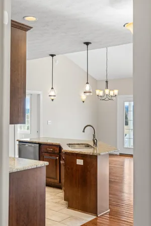 a kitchen with stainless steel appliances granite countertop a refrigerator a sink and dishwasher