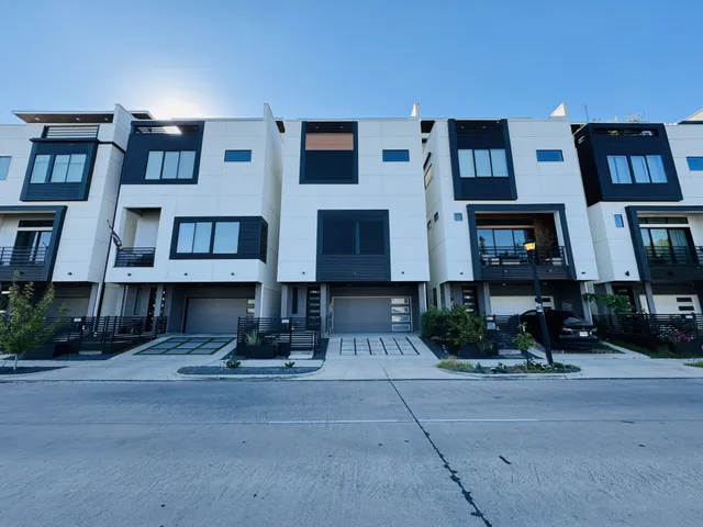 a man sitting on a bench in front of a building