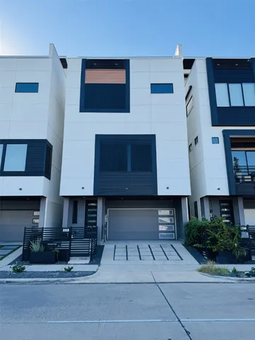 a view of building with car parked