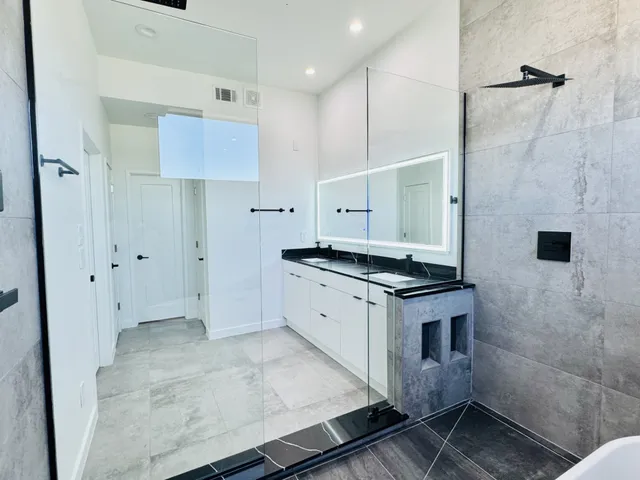 a kitchen with stainless steel appliances a stove a refrigerator and cabinets