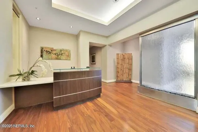 a lobby with furniture and floor to ceiling window