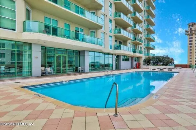 a view of a swimming pool with outdoor seating