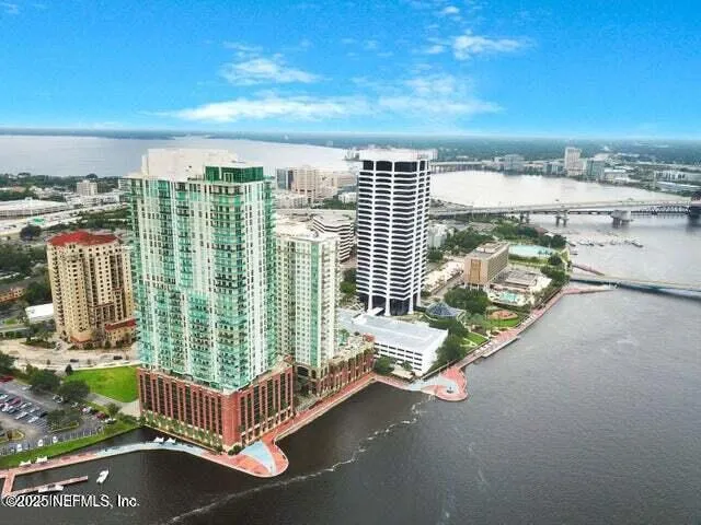 an aerial view of residential houses with outdoor space and swimming pool