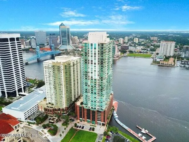 a living room with fireplace furniture and a large window