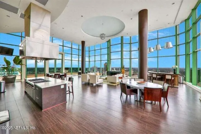 a dining room with large glass table and chairs