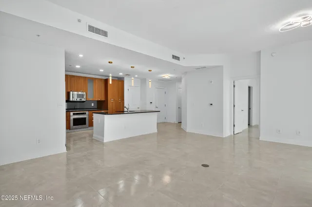 a kitchen with stainless steel appliances granite countertop a sink and cabinets