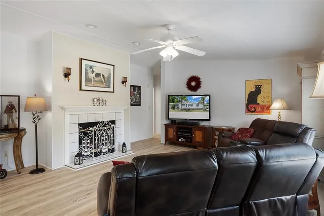a living room with furniture a fireplace and paintings on the wall