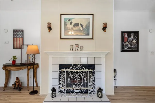 a kitchen with stainless steel appliances granite countertop a refrigerator a stove and a dining table with wooden floor